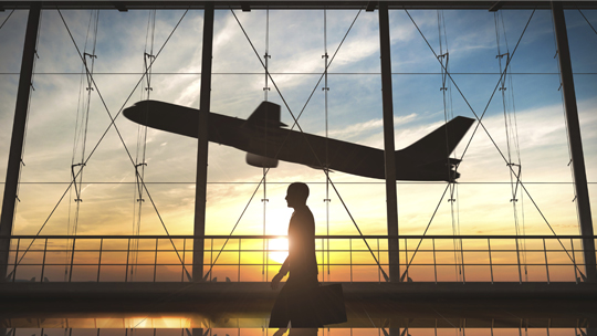 Man in airport at sunset